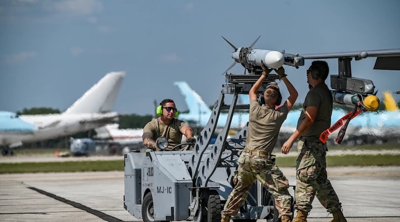 From left to right, Air Force Tech. Sgt. Anthony Barrow, 180th Maintenance Squadron (MXS) munitions systems specialist, 180th Fighter Wing, Ohio Air National Guard, Lucas County, Ohio, Airman 1st Class Andrew Stephens, 180th MXS weapons loader and Tech. Sgt. Evan Sanders, 180th MXS weapons loader, prepare an F-16C Fighting Falcon for takeoff during Exercise Northern Strike 24-2 at Oscoda-Wurtsmith Airport, Iosco County, Michigan, Aug. 14, 2024. Air National Guard photo