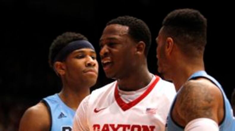 Dayton's Kendall Pollard, center, reacts after scoring against Rhode Island on Tuesday, March 3, 2015, at UD Arena. David Jablonski/Staff