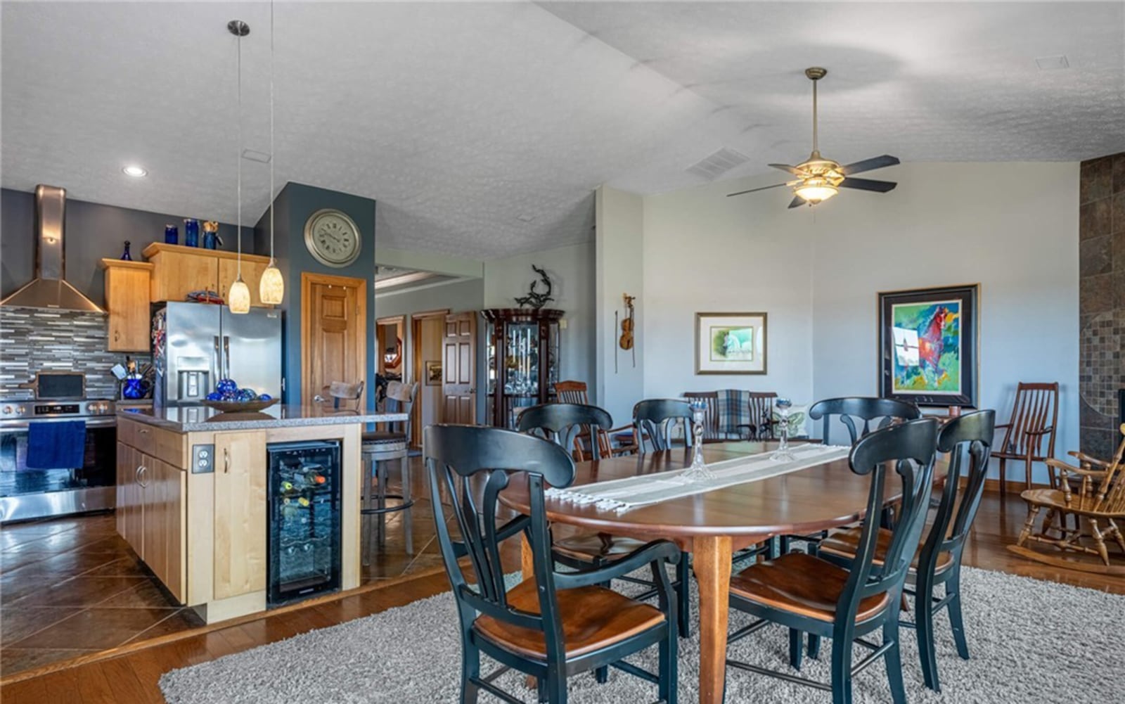 The open concept kitchen, living and dining areas have hardwood flooring with tile in the kitchen. The ceiling is vaulted with a ceiling fan and there is a corner gas fireplace. CONTRIBUTED