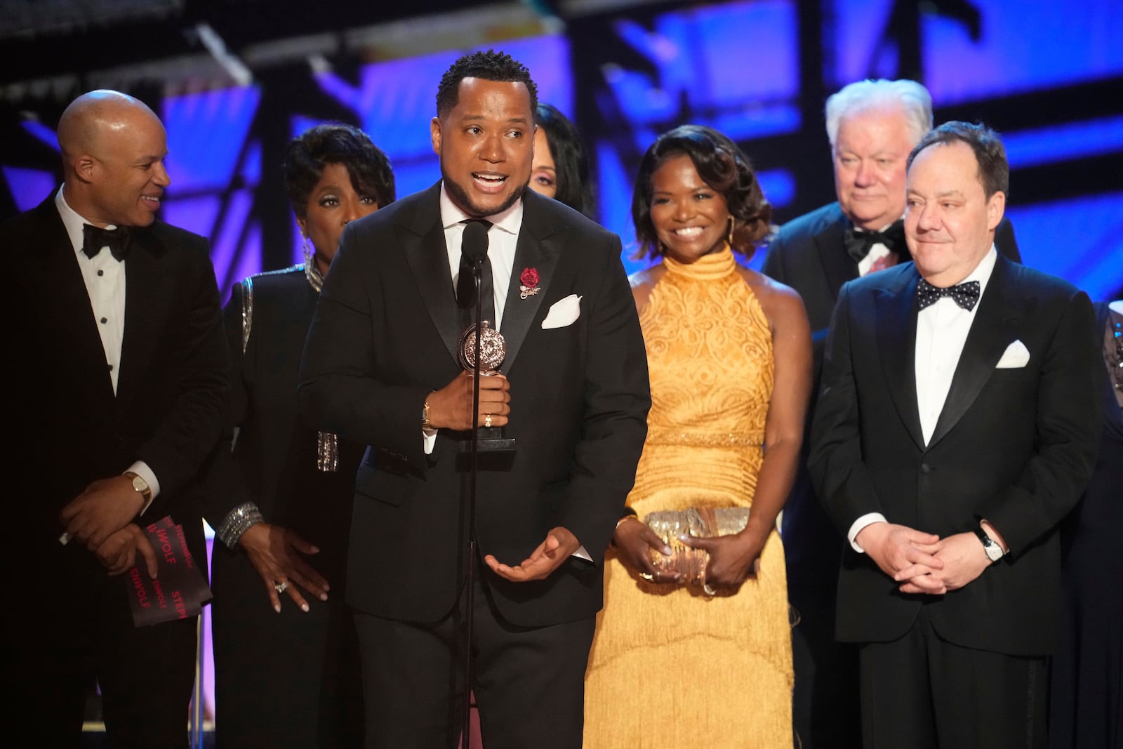 Branden Jacobs-Jenkins, center, accepts the award for best play for "Purpose" during the 78th Tony Awards on Sunday, June 8, 2025, at Radio City Music Hall in New York. (Photo by Charles Sykes/Invision/AP)