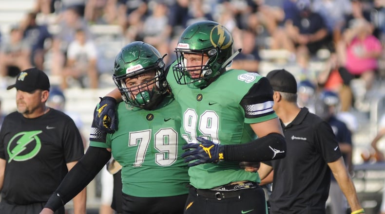 Northmont High School senior Gabe Newburg (right) is helped off the field by senior teammate David Weherley this past season. Weherley was among area players who were named to the South teams for the 74th Annual North vs. South All-Star Classic. MARC PENDLETON / STAFF