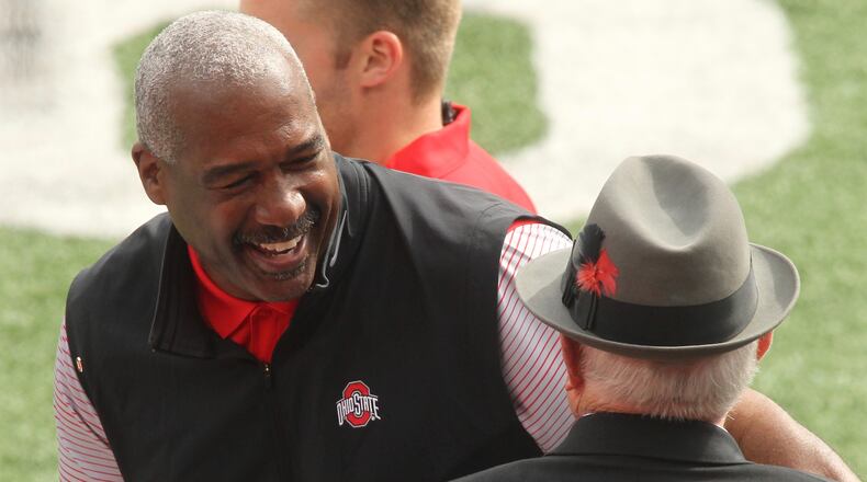 Ohio State Athletic Director Gene Smith smiles as he talks to former coach Earle Bruce before a game against Rutgers on Saturday, Oct. 1, 2016, at Ohio Stadium in Columbus. David Jablonski/Staff
