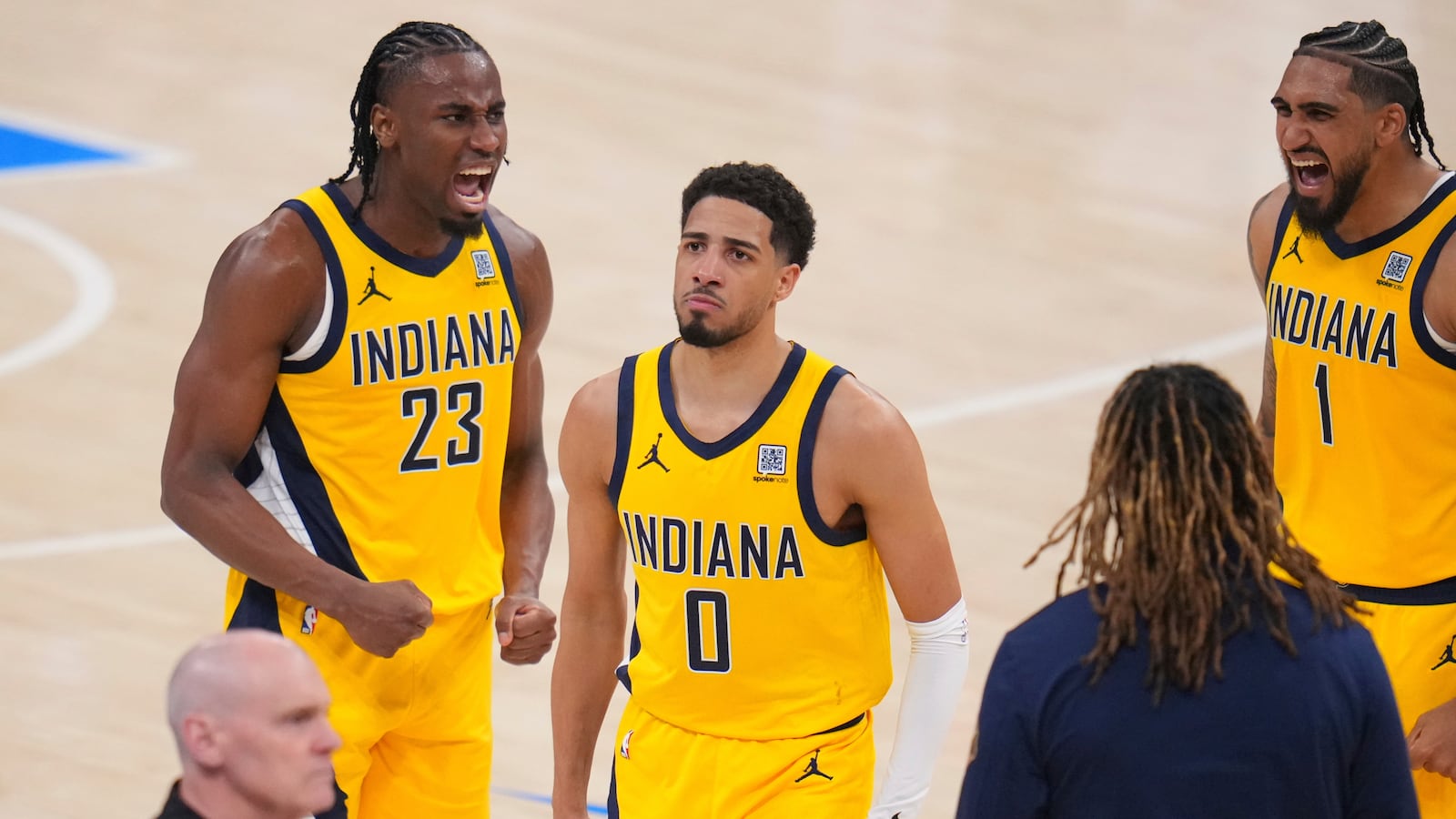 Indiana Pacers guard Tyrese Haliburton (0) celebrates with forward Aaron Nesmith (23) and forward Obi Toppin (1) after making a 3-pointer against the Oklahoma City Thunder during the second half of Game 1 of the NBA Finals basketball series Thursday, June 5, 2025, in Oklahoma City. (AP Photo/Julio Cortez)