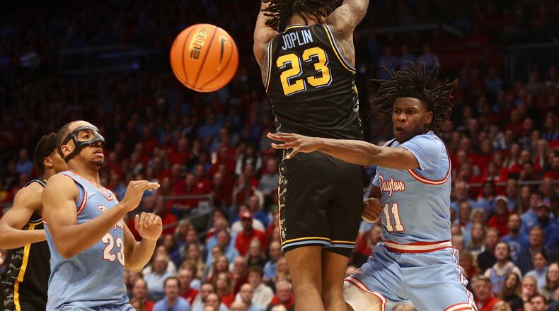 Dayton's Malachi Smith makes a pass against Marquette on Saturday, Dec. 14, 2024, at UD Arena. David Jablonski/Staff