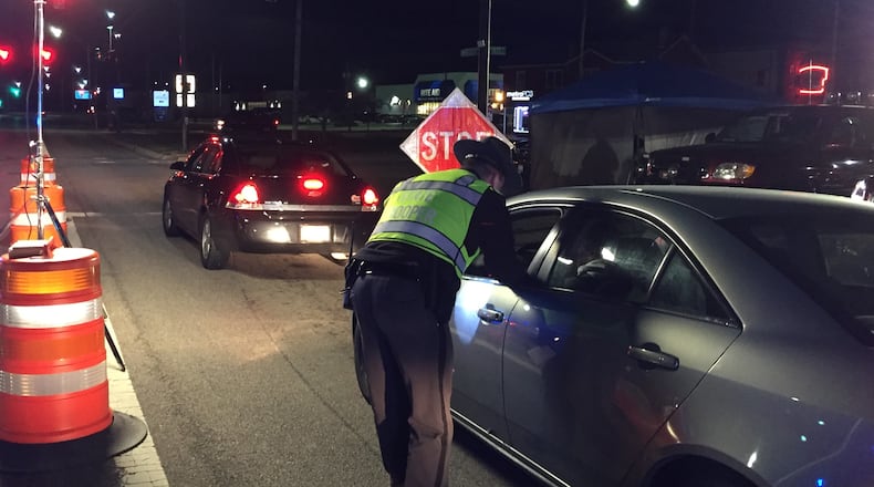 An Ohio State Highway Patrol trooper checks a driver during an OVI checkpoint at University Boulevard and First Avenue in Middletown on Jan. 17, 2020. The checkpoint was the latest organized by the Butler County OVI Task Force. The Middletown checkpoint was conducted by Middletown police, the highway patrol, and Butler County Sheriff’s deputies. ED RICHTER/STAFF