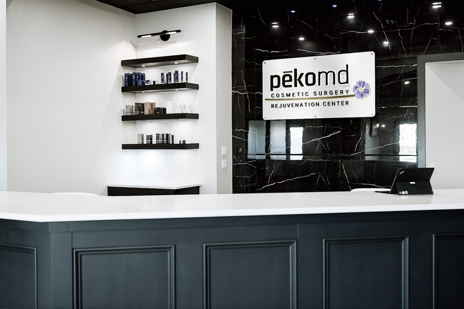 Pēkomd Dayton, which is located at 6728 Loop Road, Centerville, plans to hold a June 7 grand opening event. Pictured is a receptionist desk at the new location, featuring skincare products. CONTRIBUTED