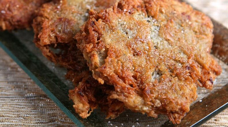Latkes, also commonly called potato pancakes, are prepared by frying grated potato and onions. (Roberto Rodriguez/St. Louis Post-Dispatch/TNS)