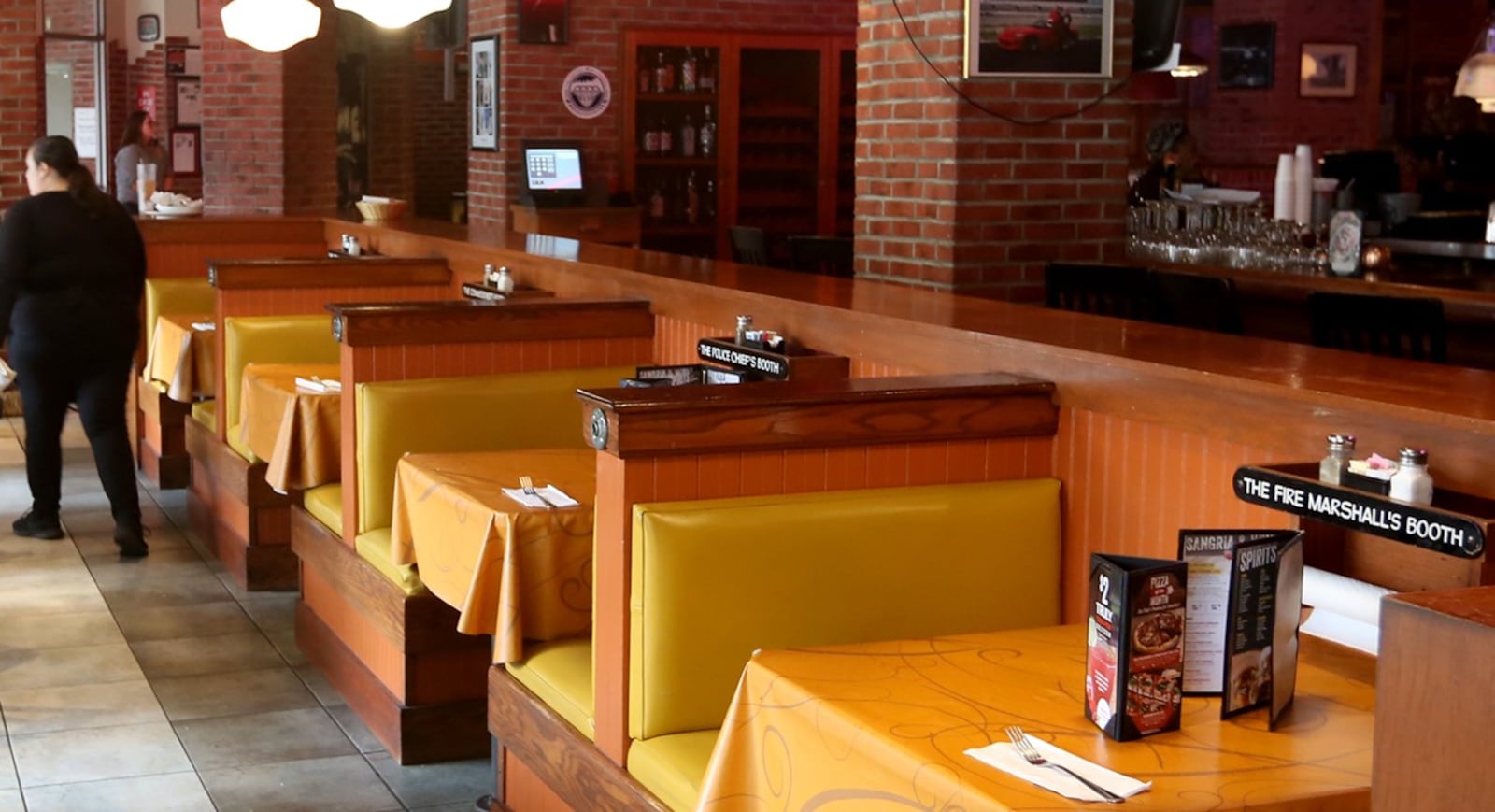 A photo of the Uno Chicago Bar & Grill in downtown Dayton that was taken in the late 2010s. The restaurant closed in 2024. Some booths had nicknames printed on signs attached to the wall mounted paper towel racks. A former Dayton police lieutenant was investigated for removing and taking three signs in May 2025. STAFF