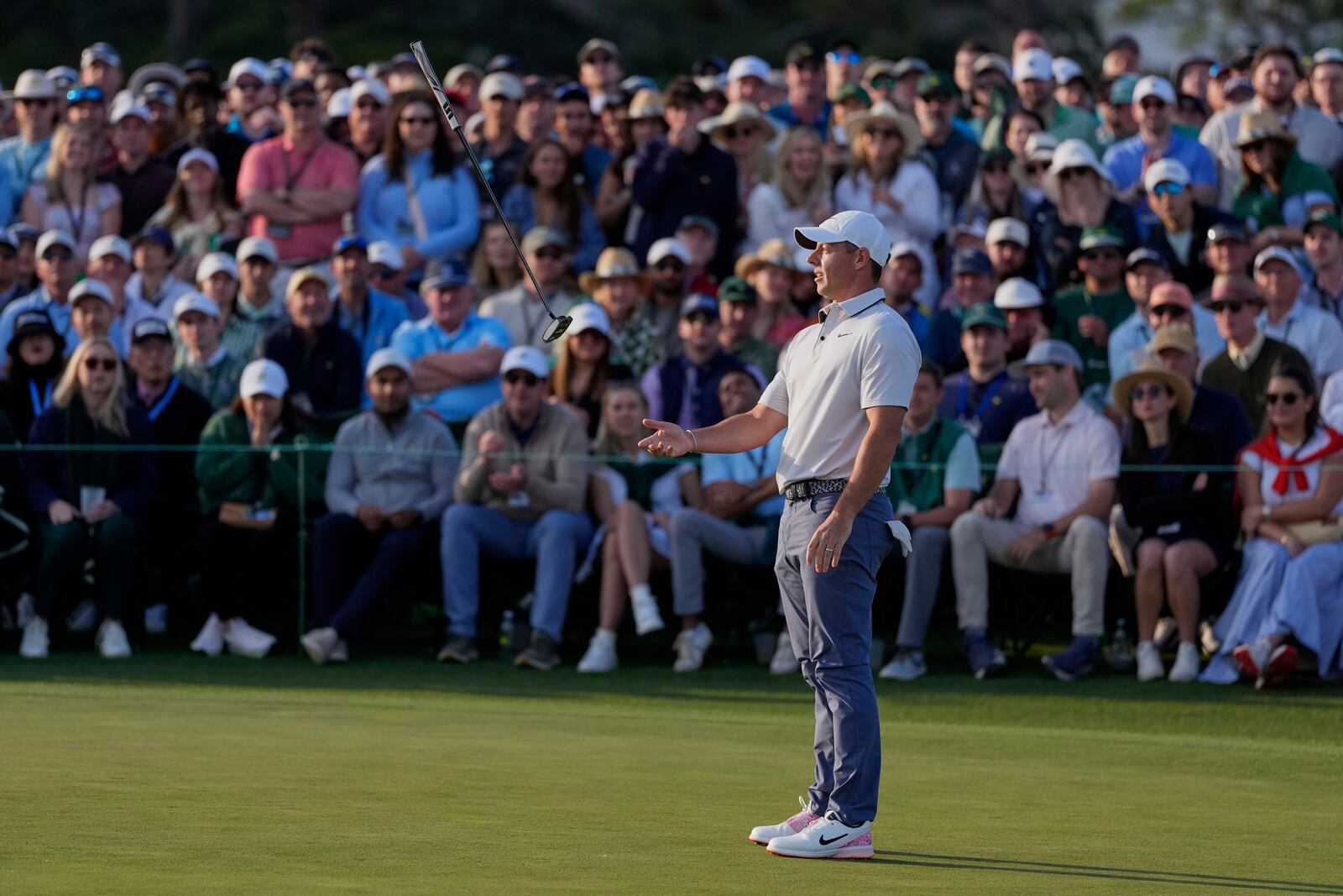 Rory McIlroy, of Northern Ireland, tosses his putter on the 18th hole during the third round at the Masters golf tournament, Saturday, April 12, 2025, in Augusta, Ga. (AP Photo/Ashley Landis)