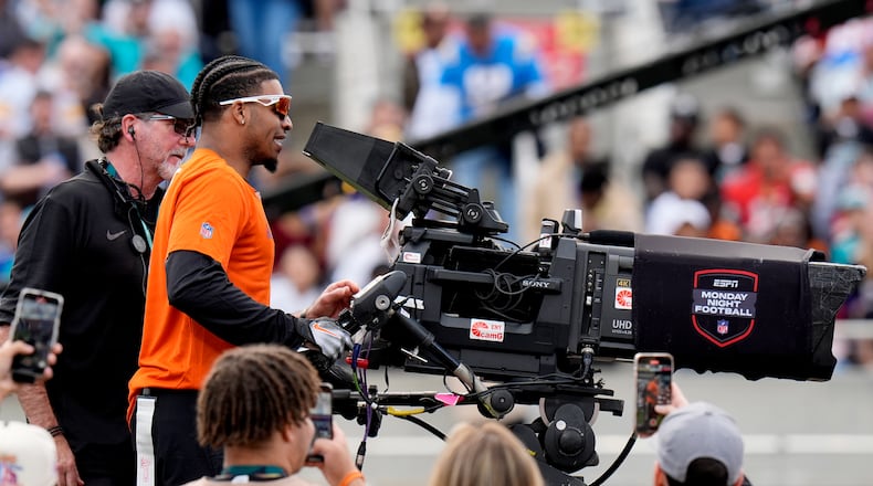 AFC Cincinnati Bengals wide receiver Ja'Marr Chase operates the TV camera after scoring a touchdown against the NFC during the flag football event at the NFL Pro Bowl football game, Sunday, Feb. 4, 2024, in Orlando. (AP Photo/Chris O'Meara)