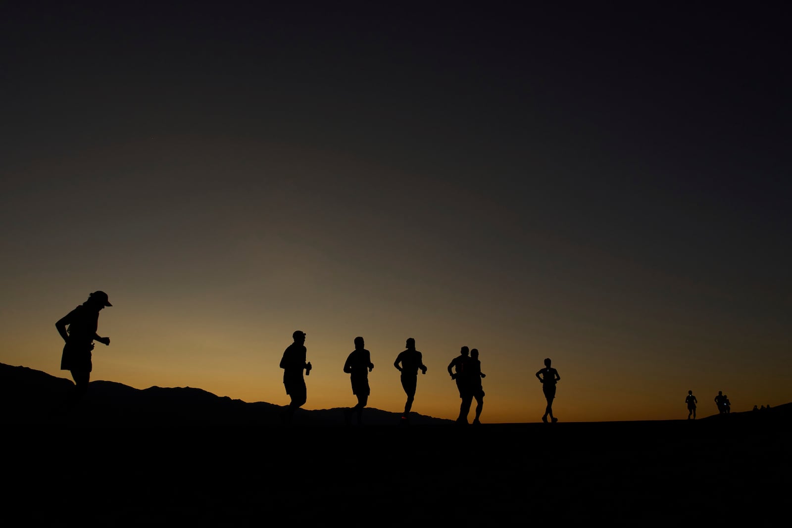 Danny Westergaard, leading the center group of runners, competes during the Badwater 135 Ultramarathon, Monday, July 7, 2025, near Badwater Basin in Death Valley National Park, Calif. (AP Photo/John Locher)