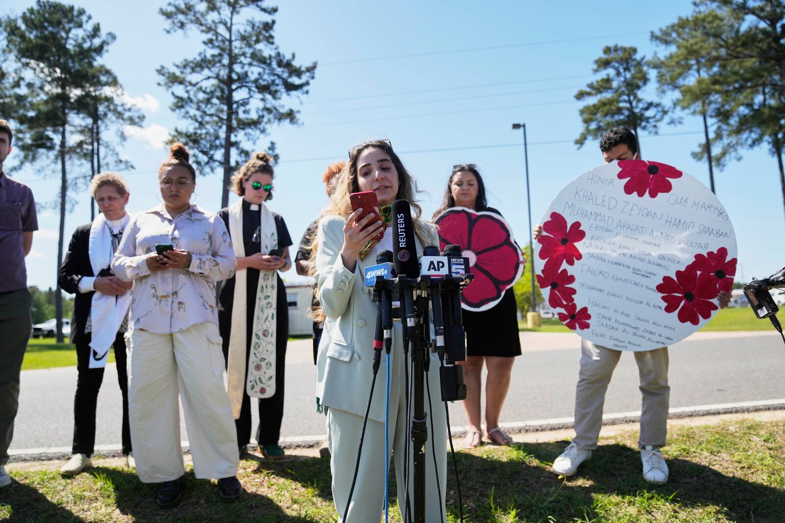 Human rights attorney Sabrine Mohamed reads a message from Mahmoud Khalil, the Columbia University activist facing deportation for his role in pro-Palestinian campus protests, after his immigration hearing, outside the Central Louisiana Ice Processing Center in Jena, La., Friday, April 11, 2025. (AP Photo/Gerald Herbert)