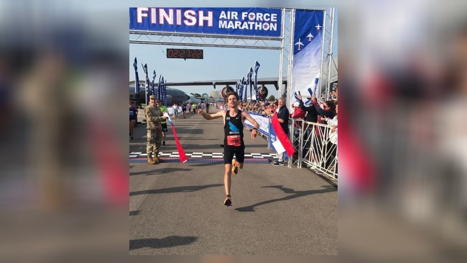 Jason Salyer crosses the finish line Saturday as the winner of the men's division of the Air Force Marathon. Tom Archdeacon/STAFF
