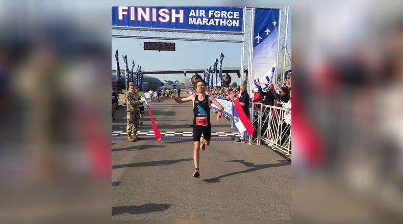 Jason Salyer crosses the finish line Saturday as the winner of the men's division of the Air Force Marathon. Tom Archdeacon/STAFF
