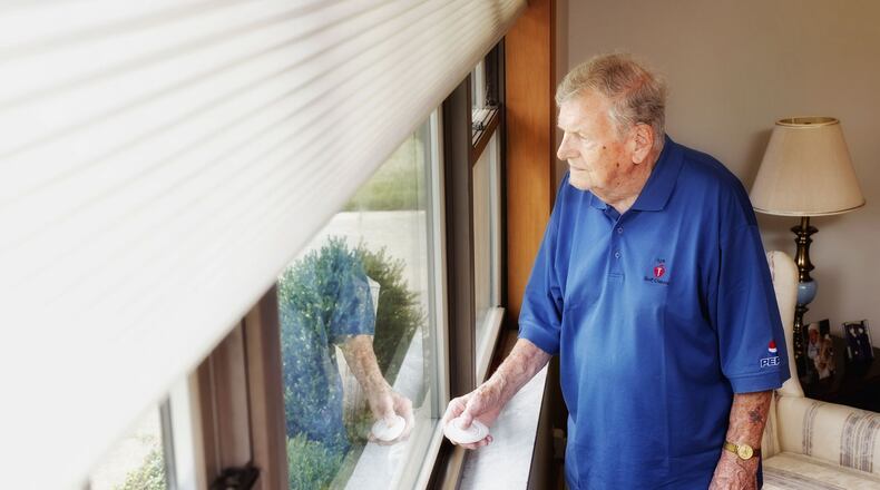 Hal Pearce uses remote controlled window shades in his home in Middletown. The controller makes it easy to raise and lower the shades with the push of a button. NICK GRAHAM/STAFF