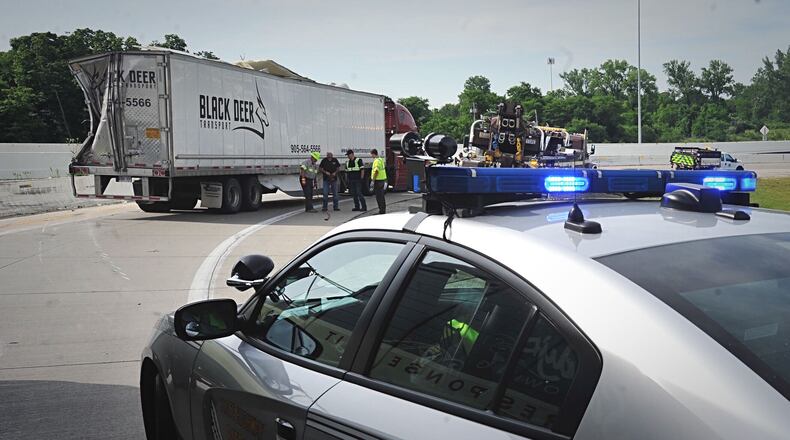 A semi-truck rolled onto its side on the I-70 east ramp to I-75 north Friday morning, closing the ramp for nearly three hours. STAFF PHOTO / MARSHALL GORBY