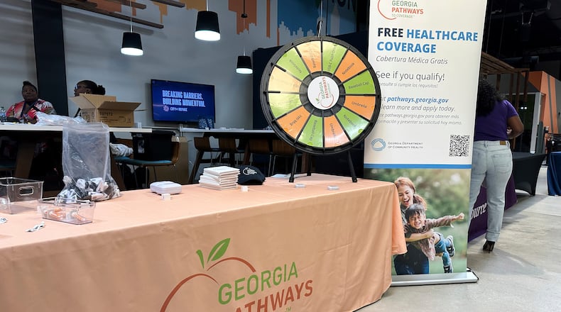 FILE - A stand for Georgia Pathways is seen at a job fair in Atlanta, Ga., June 5, 2025. (AP Photo/Sudhin Thanawala, File)