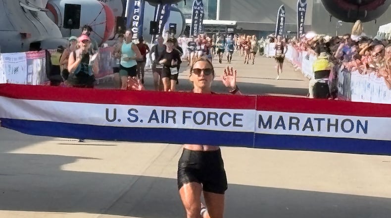 Air Force Marathon women's champion Kayla Brown hits finish line on Saturday morning at Wright Patterson Air Force Base. TOM ARCHDEACON