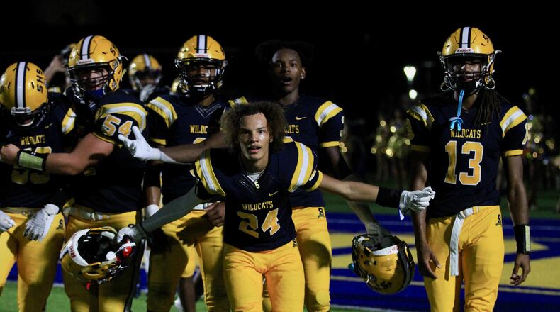 Springfield players, including Duncan Bradley (24), celebrate a victory against Saint Ignatius on Friday Aug. 20, 2021, at Springfield High School. David Jablonski/Staff