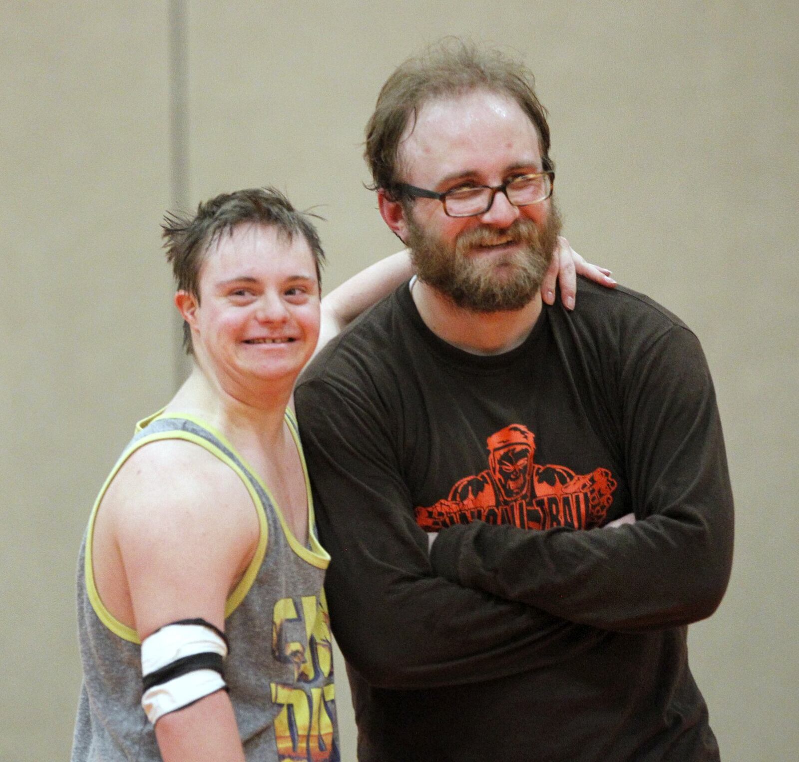 Brooks Henning and National Trail High School wrestling coach Michael Eyler at a recent practice. Henning, who has Down Syndrome, wrestles with the team. LISA POWELL / STAFF