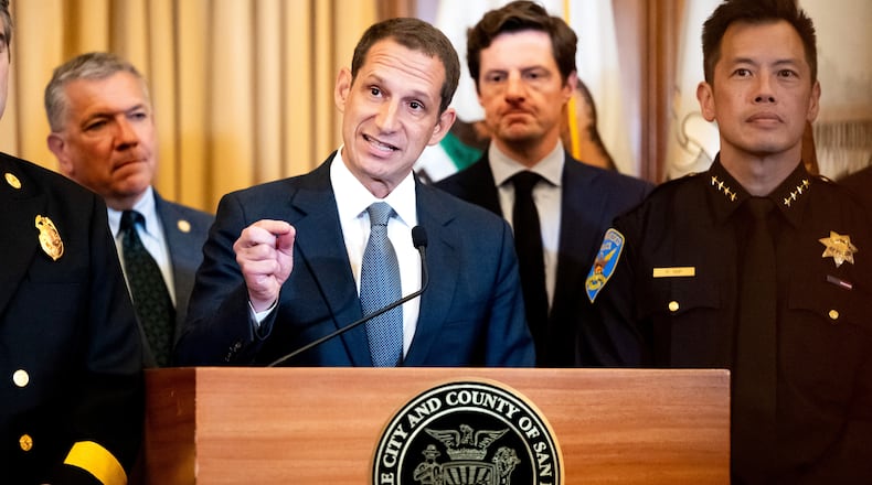 Flanked by city leaders, San Francisco Mayor Daniel Lurie discusses President Donald Trump's comments that he has called off a surge of federal law enforcement in San Francisco on Thursday, Oct. 23, 2025, in San Francisco. (AP Photo/Noah Berger)