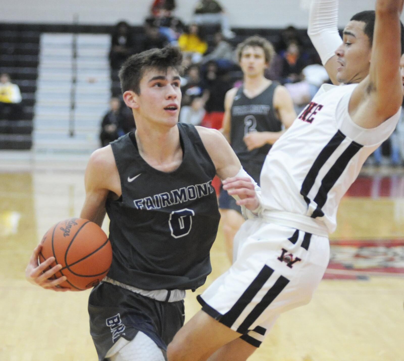 Ryan Hall of Fairmont (with ball) drew a charge from Wayne’s Cam Fancher. Wayne defeated visitnig Fairmont 58-38 in a boys high school basketball game on Tuesday, Jan. 29, 2019. MARC PENDLETON / STAFF