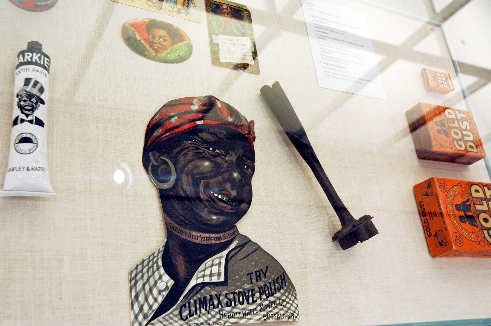In this Jan. 11, 2018 photo, artifacts inside a display case, including a branding iron, are included in the slavery and segregation collection by Alan Page, NFL Hall of Famer and retired Minnesota Supreme Court Justice, and his wife, Diane Sims Page, displayed at the Minneapolis Central Library this month in time for Super Bowl visitors and thousands of other people expected to flock to downtown for the festivities. (AP Photo/Steve Karnowski)