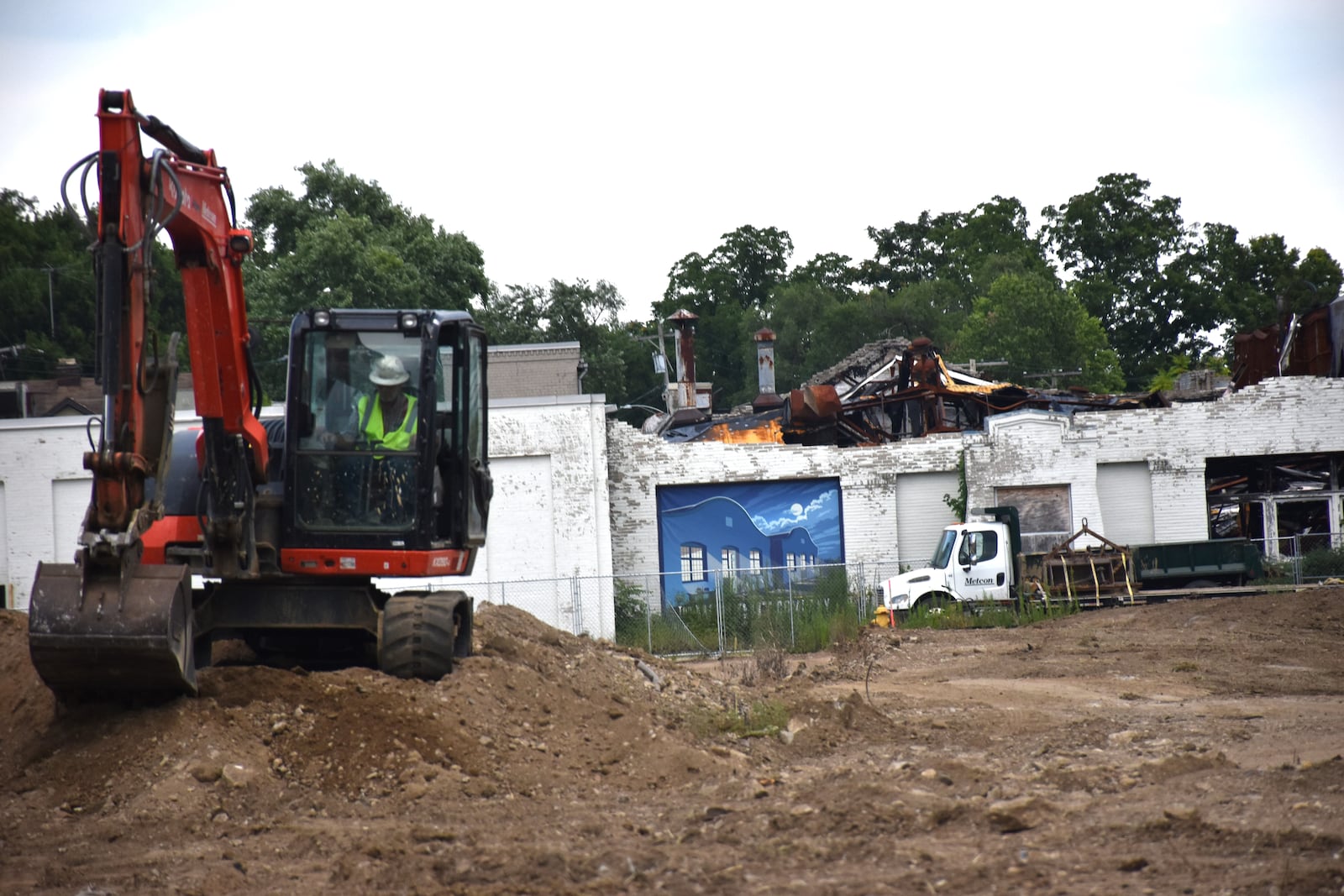 Construction crews work on a site near the historic Wright Co. airplane factory buildings in West Dayton. The hangars were heavily damaged by fire on March 26, 2023. Officials say part of the facade of building 1 partially collapsed recently, likely in July 2025. CORNELIUS FROLIK / STAFF