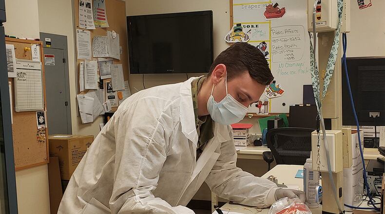 Senior Airman Brian Holloway logs COVID-19 specimens collected from the 88th Medical Group testing site before they are transported to the 711th Human Performance Wing’s Epidemiology Laboratory. (U.S. Air Force photo)