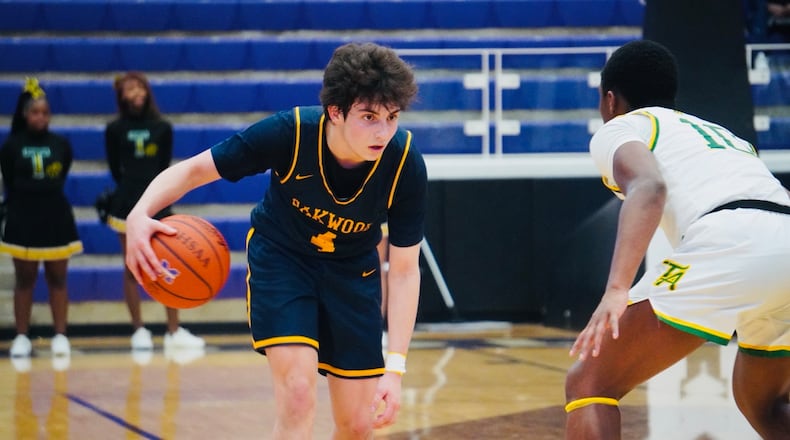 Oakwood's Luke Rubin (4) is guarded by Taft's Jaionte Jones (10) on Saturday at Wade E. Miller Arena. Chris Vogt/CONTRIBUTED