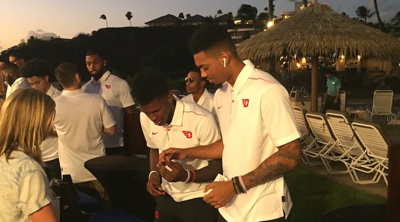 Dayton's Dwayne Cohill and Ibi Watson check out the sunglasses selection Saturday in Hawaii. Larry Hansgen/STAFF