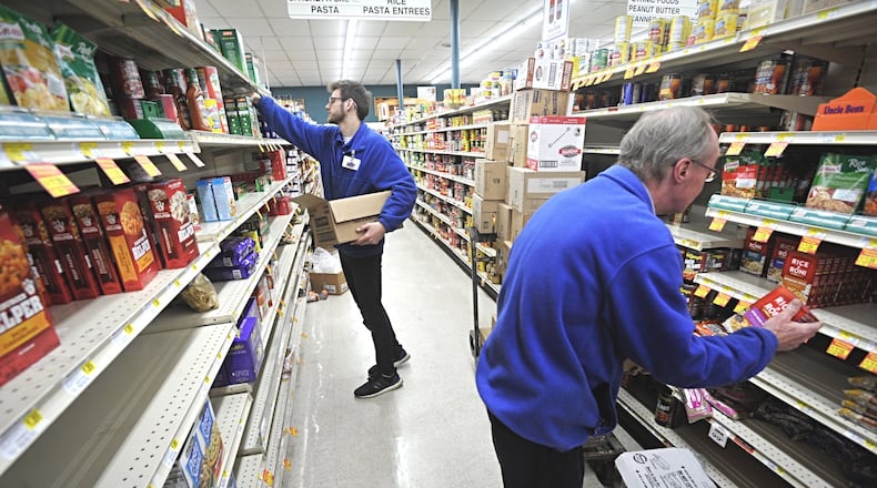 Dots Market employees, left, Max Sands and Bob Brown, along with others have been working seven days week to help the store stay stocked up for customers. MARSHALL GORBYSTAFF