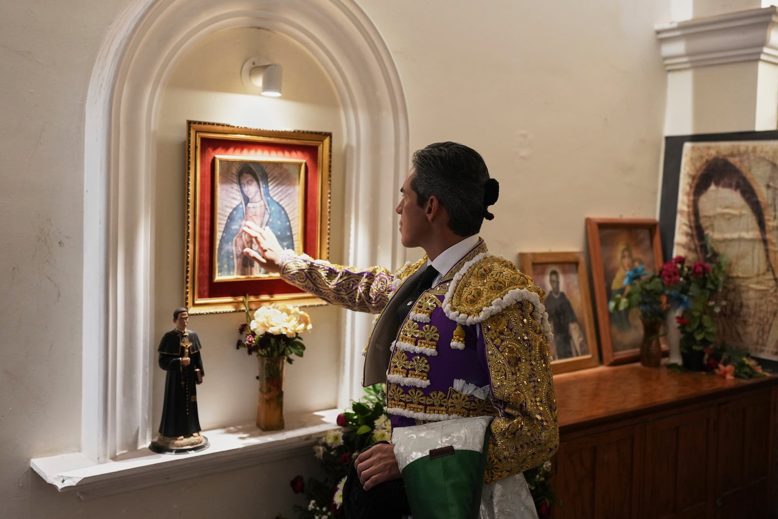 Mexican bullfighter Diego Silveti touches an image of the Virgin of Guadalupe in the bullring chapel before a bullfight in Aguascalientes, Mexico, Sunday, April 27, 2025. (AP Photo/Eduardo Verdugo)