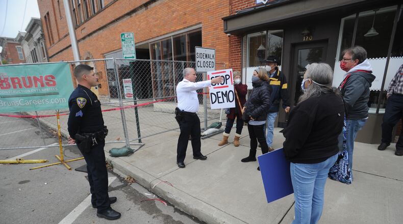 Several concerned Troy area residents protest the demolition of a Main Street building that housed an early county courthouse and an array of well-known businesses. A decision on whether to demolish the three-story building at 112-118 W. Main St. that was damaged during a January tornado that struck downtown Troy was delayed Wednesday by Troy Planning Commission.