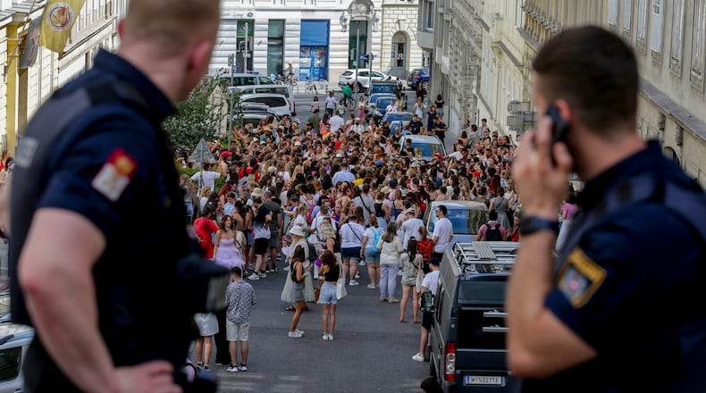 FILE - Austrian police officers watch swifts gathering in the city centre in Vienna on Aug.8, 2024. (AP Photo/Heinz-Peter Bader, file)