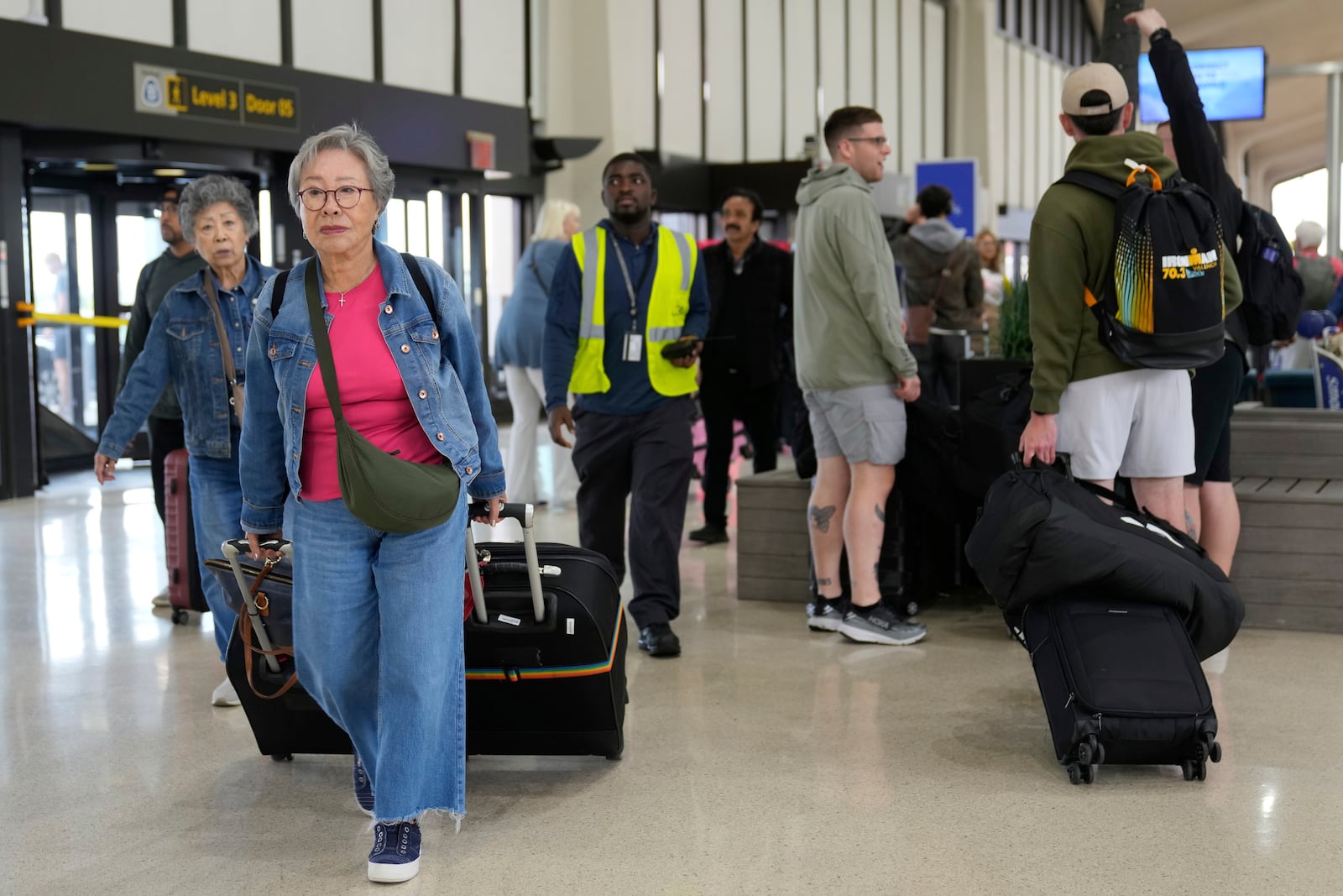 People prepare to board flights at Newark Liberty International Airport in Newark, N.J., Monday, May 5, 2025. (AP Photo/Seth Wenig)