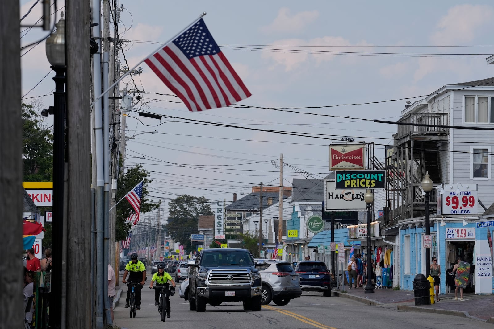 Community Service Officers from the Old Orchard Beach Police Dept. patrol on bicycles, Tuesday, July 29, 2025, in Old Orchard Beach, Maine. (AP Photo/Robert F. Bukaty)