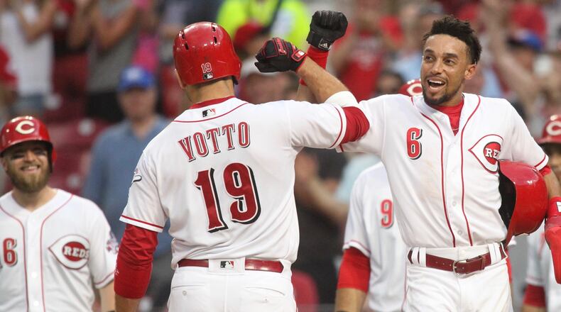 The Reds’ Joey Votto celebrates with Billy Hamilton after hitting a grand slam against the Tigers on Tuesday, June 19, 2018, at Great American Ball Park in Cincinnati. David Jablonski/Staff