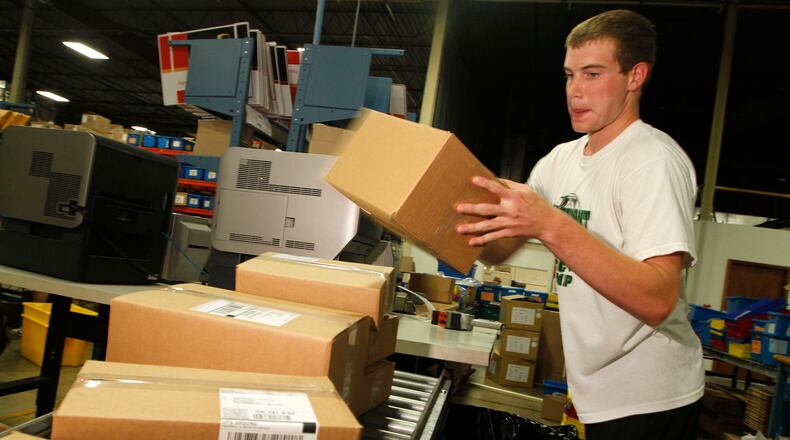 A shipping employee for Lastar — the predecessor company to C2G — packages boxes in this 2010 photo.