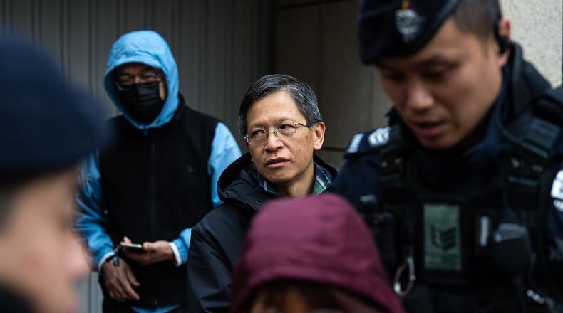 Pro-democracy activist Tang Ngok-kwan waits outside the West Kowloon Magistrates' Courts to attend a trial under a China-imposed national security law on Thursday, Jan. 22, 2026, in Hong Kong. (AP Photo/Chan Long Hei)