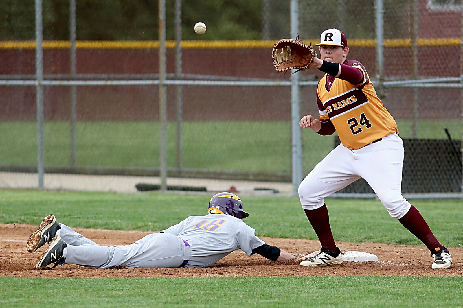 Eaton’s Bradley Curry avoids the pickoff attempt and the throw to Ross first baseman Drew Huffman during their Division II sectional game at Ross on Thursday. CONTRIBUTED PHOTO BY E.L. HUBBARD