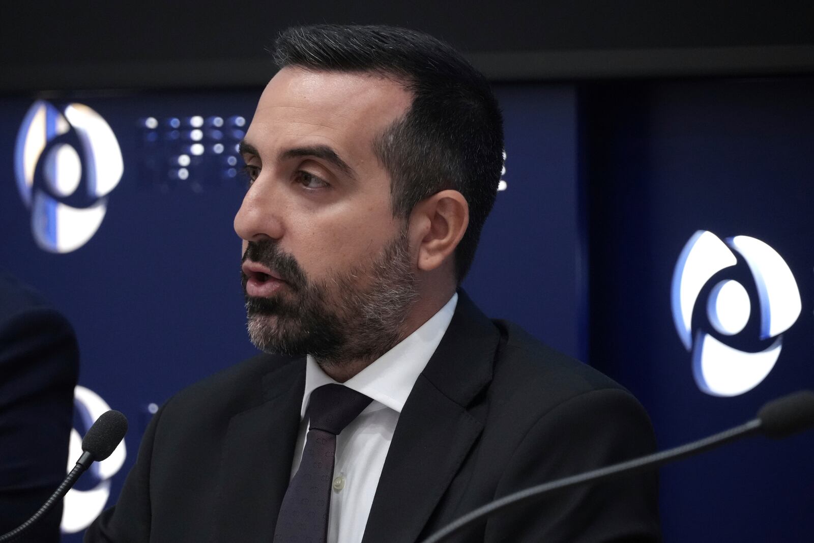 Cyprus' deputy minister for migration Nicholas Ioannides explains how a new voluntary repatriation program for Syrian families living in Cyprus will work during a press conference, at the Press and Informations office in the capital Nicosia, Cyprus, Thursday, May 29, 2025. (AP Photo/Petros Karadjias)