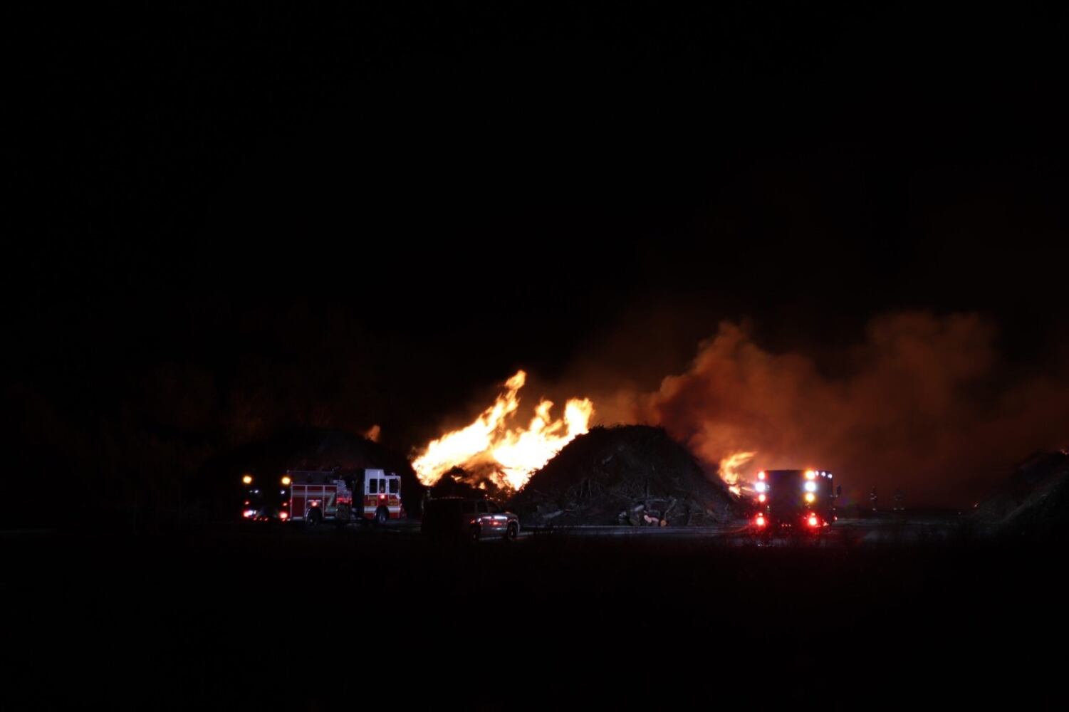 Fire crews battling huge fire in wood piles on Harshman Road