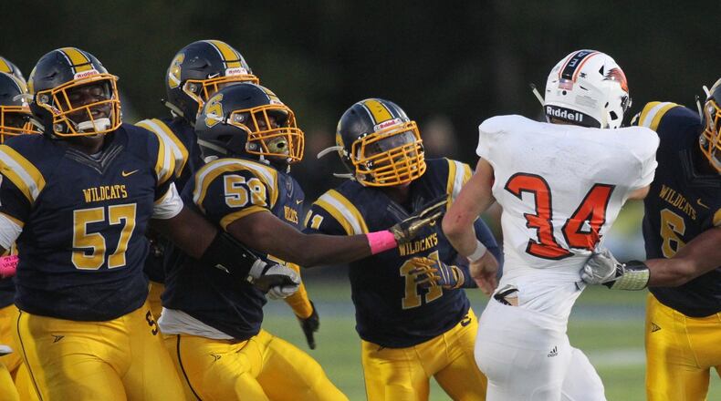 Springfield’s Jalen Minney, right, tackles Beavercreek’s Elijah Howard in the first half on Friday, Oct. 5, 2019, at Springfield High School. David Jablonski/Staff