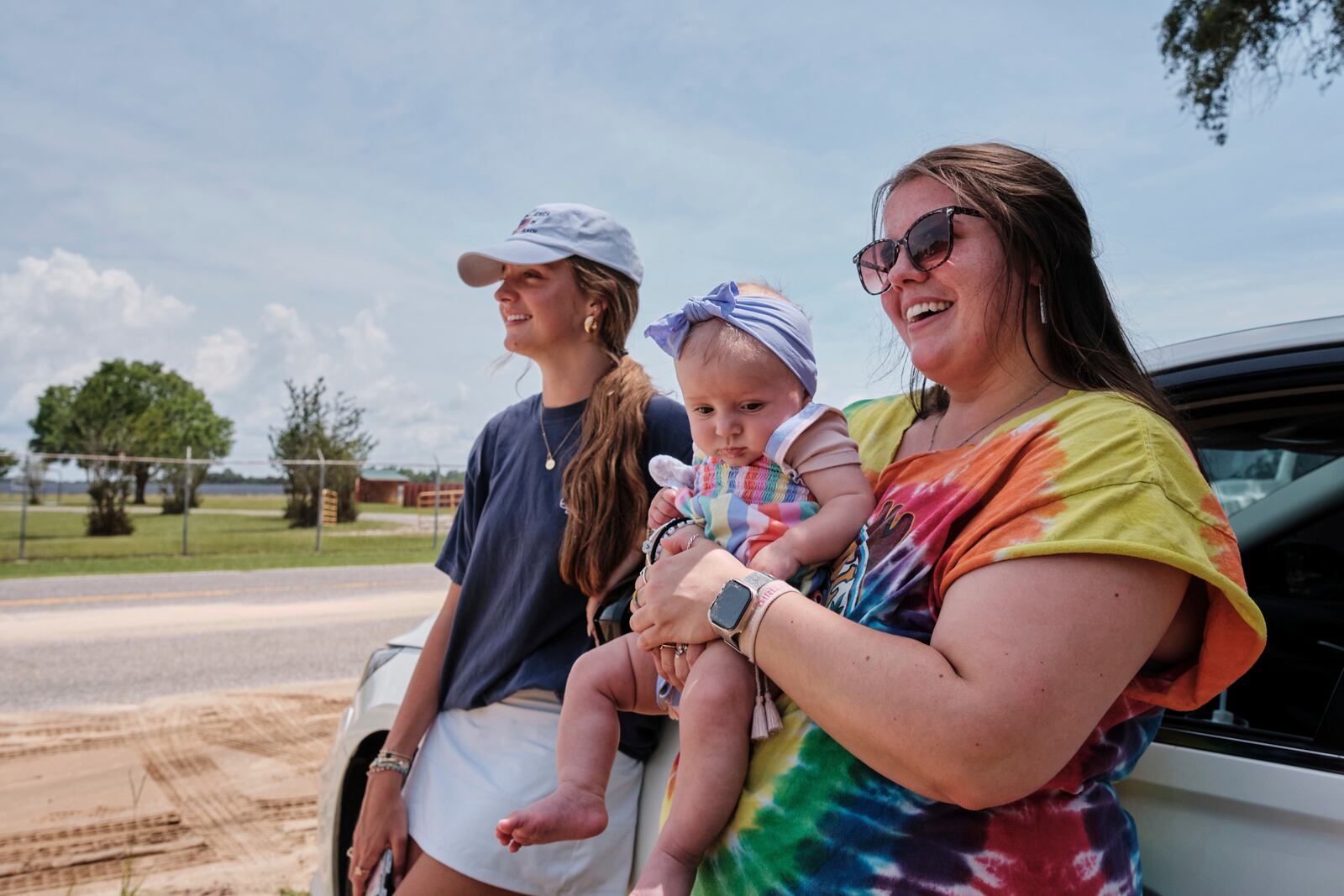 Fans Emma Touchstone, 17, left, and Kelsey Heath with her four-month-old daughter Maggie Fields wait for reality television star Todd Chrisley walks out of the Federal Prison Camp, Wednesday, May 28, 2025, in Pensacola, Fla. (AP Photo/Dan Anderson)