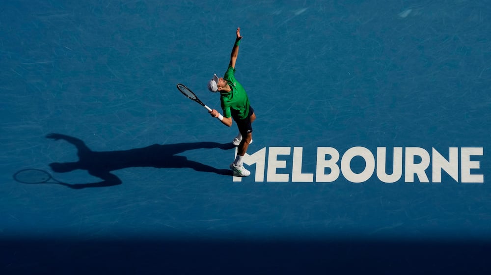 Novak Djokovic of Serbia plays a forehand return to Lorenzo Musetti of Italy during their quarterfinal match at the Australian Open tennis championship in Melbourne, Australia, Wednesday, Jan. 28, 2026. (AP Photo/Aaron Favila)