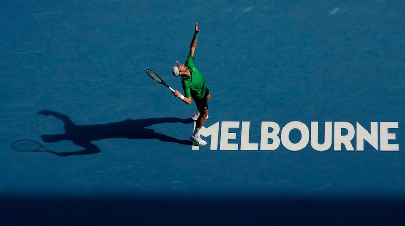 Novak Djokovic of Serbia plays a forehand return to Lorenzo Musetti of Italy during their quarterfinal match at the Australian Open tennis championship in Melbourne, Australia, Wednesday, Jan. 28, 2026. (AP Photo/Aaron Favila)