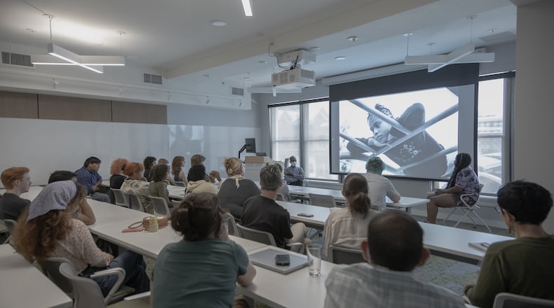 Photographer Teju Cole (pictured top left) conducts a Master Class for area students. Here, he praises the work of Stivers’ junior Sanaa Averette (top right). The playground photo is of her sister. ALLISON MESSER/THE CONTEMPORARY DAYTON