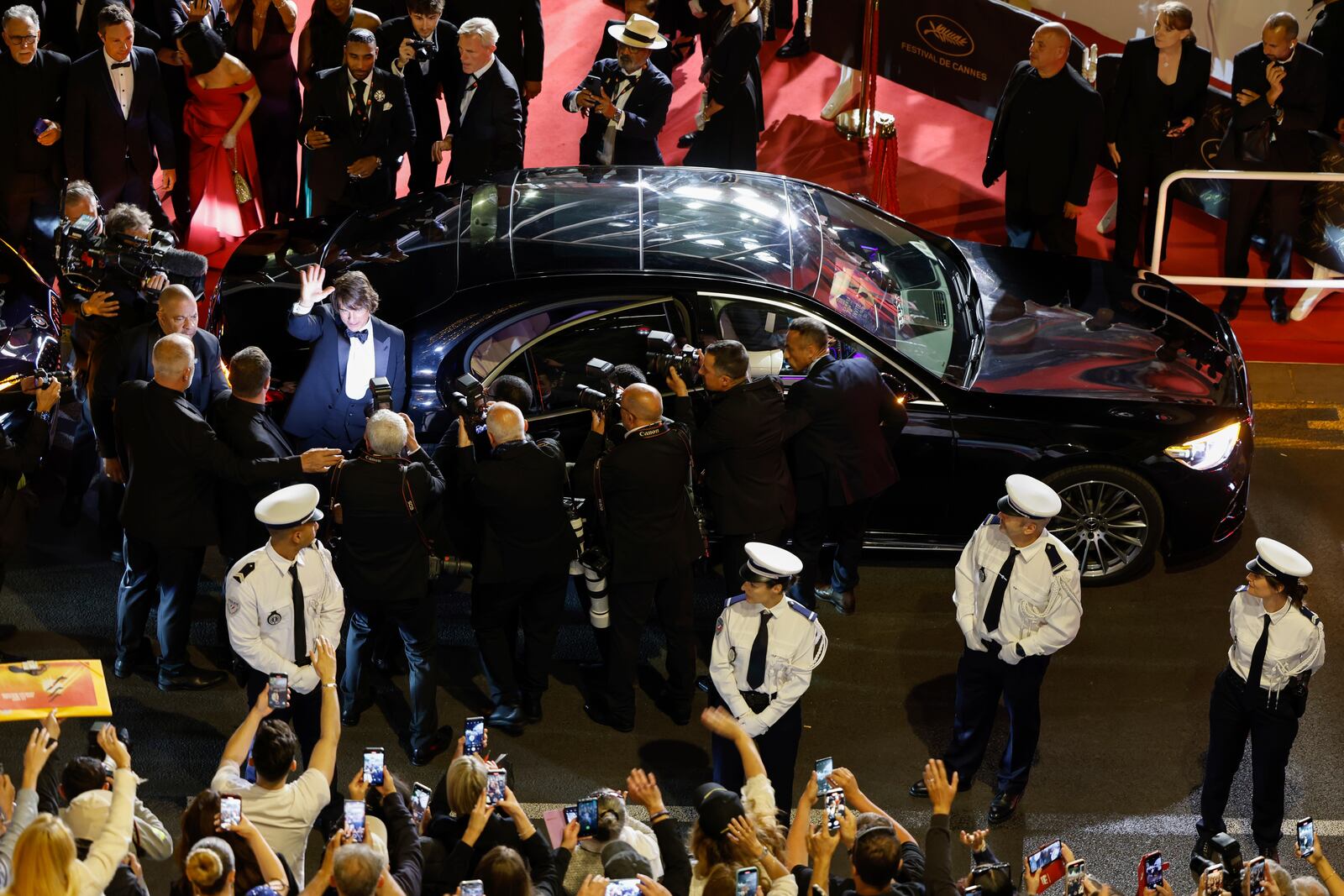 Tom Cruise waves to fans upon departure from the premiere of the film 'Mission: Impossible – The Final Reckoning' at the 78th international film festival, Cannes, southern France, Wednesday, May 14, 2025. (Photo by Millie Turner/Invision/AP)