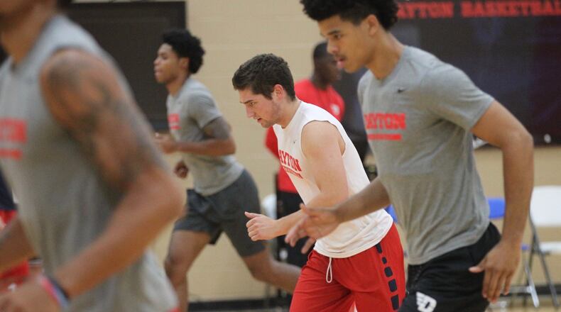 Daytonâs Jack Westerfield, center, warms up before practice on Sept. 26, 2018, at the Cronin Center. David Jablonski/Staff